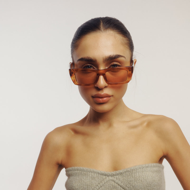 model wearing the florence sunglasses by vehla eyewear in honey tort / cinnamon