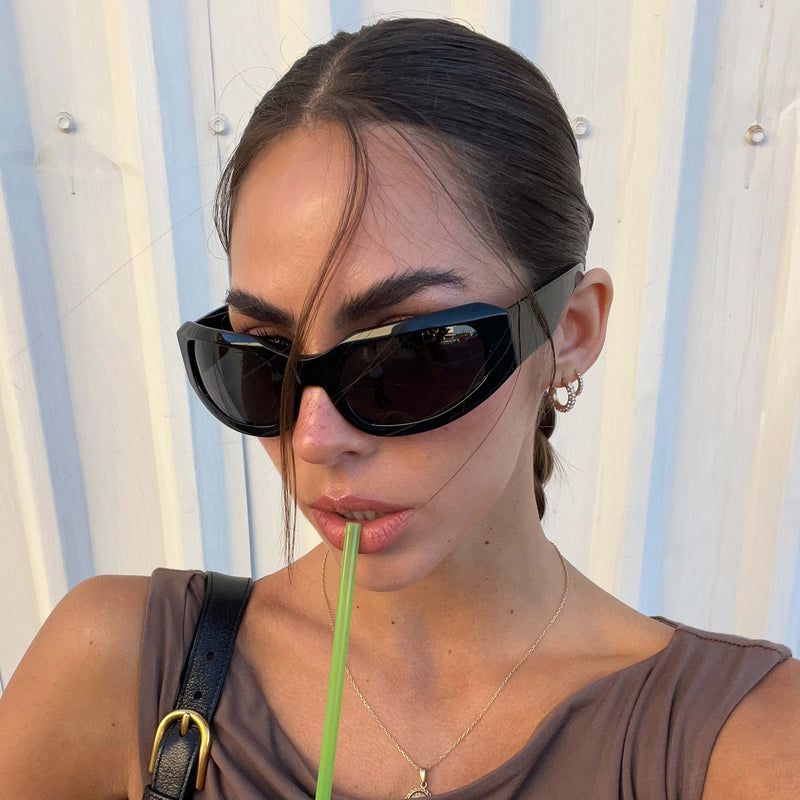model outside wearing the gia in black / smoke sunglasses from Vehla eyewear