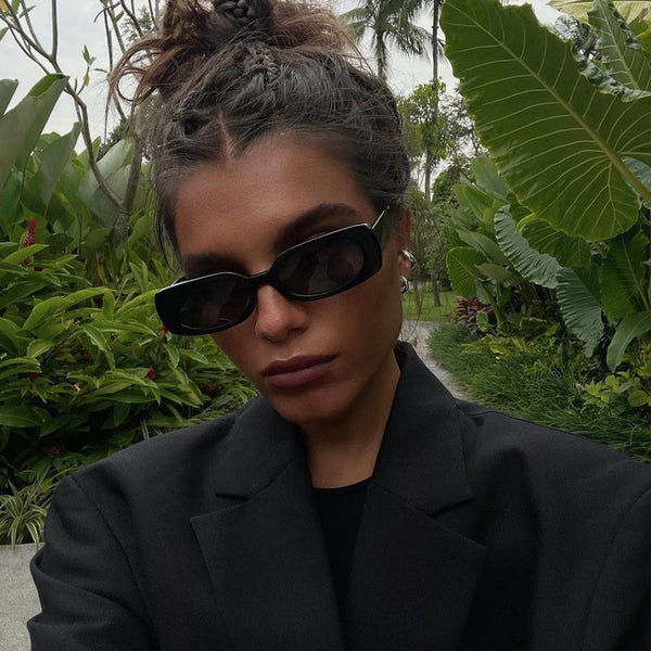model outside wearing the olsen black smoke sunglasses from Vehla eyewear