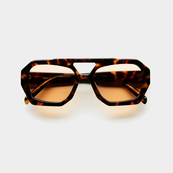 front image showing the arm of vehla eyewear river sunglasses in choc tort / cinnamon
